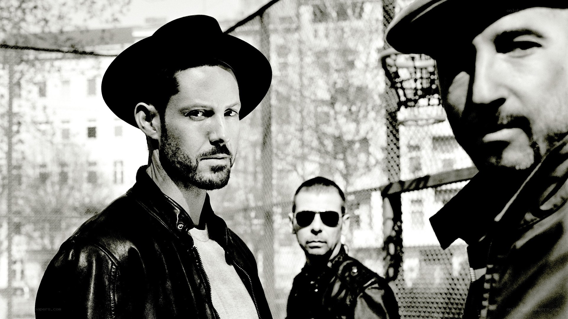 three men in hats and leather jackets