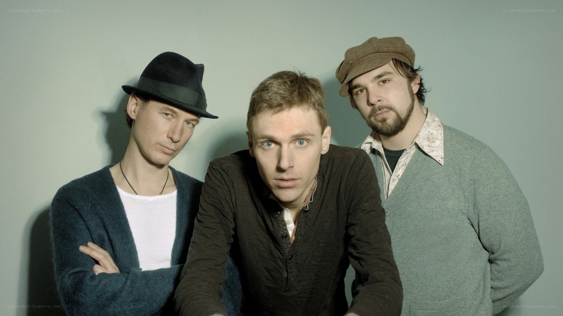 three men in hats posing