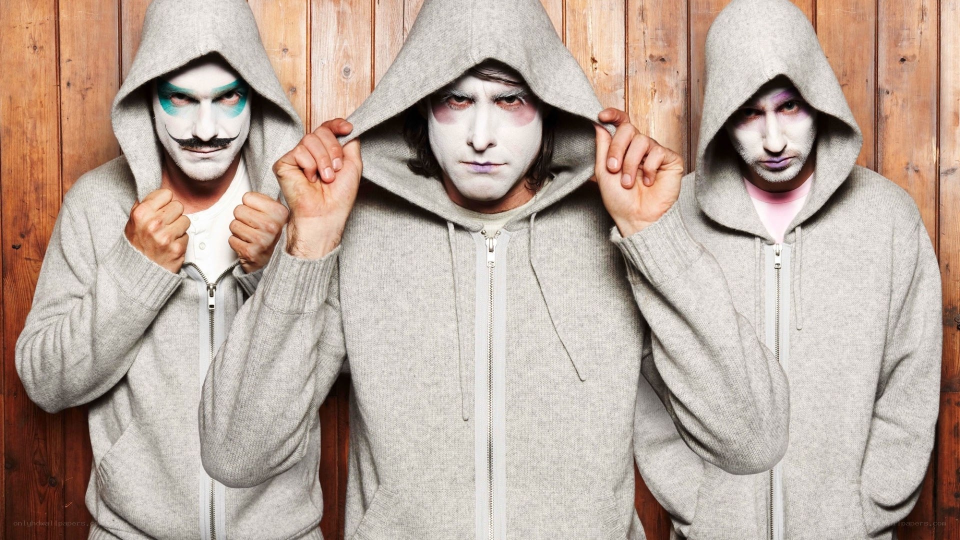 Three men in hooded sweatshirts