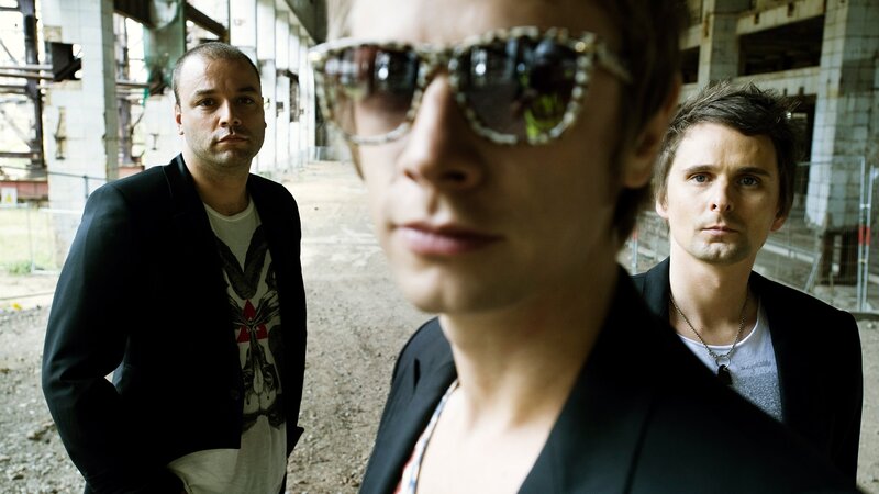 Three Men in Industrial Setting — Black, Serious