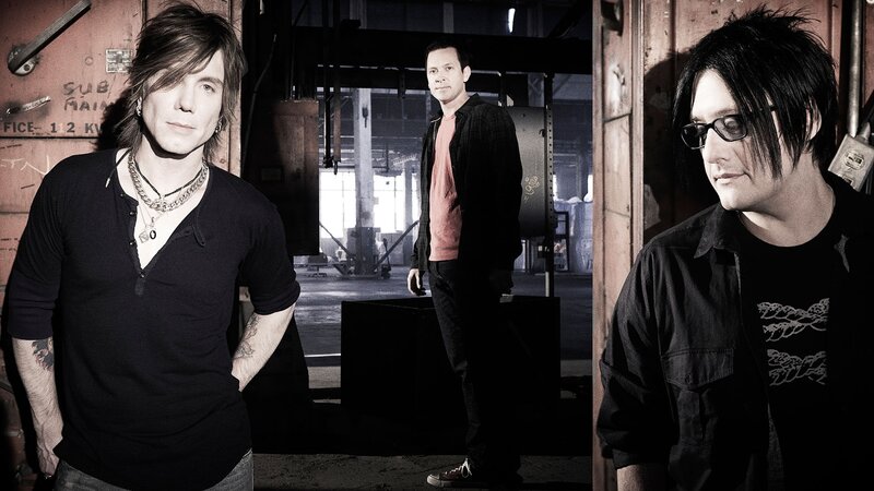 three men in industrial setting