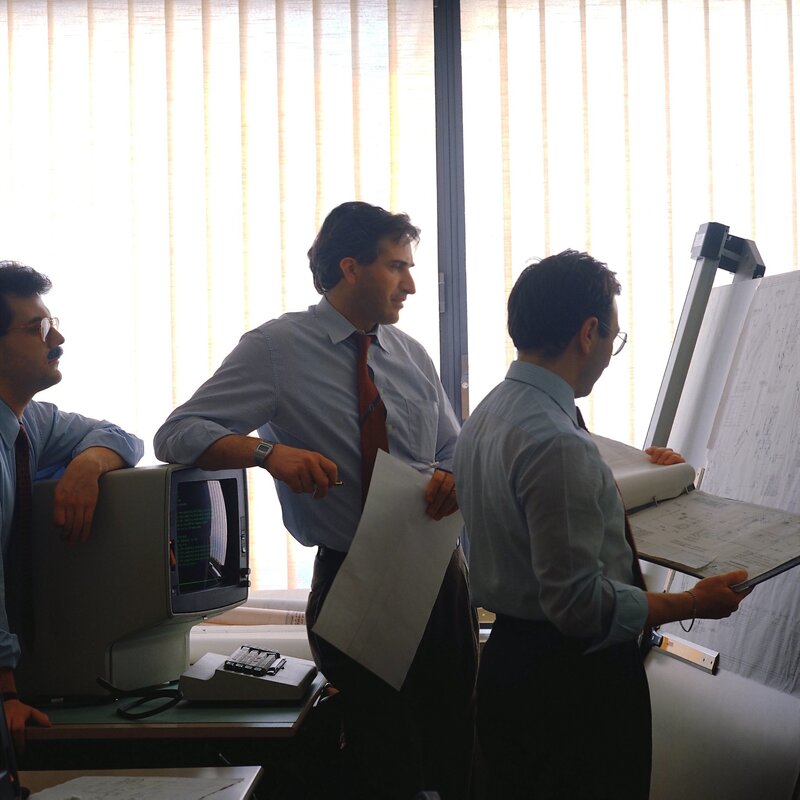 Three men in office discussion