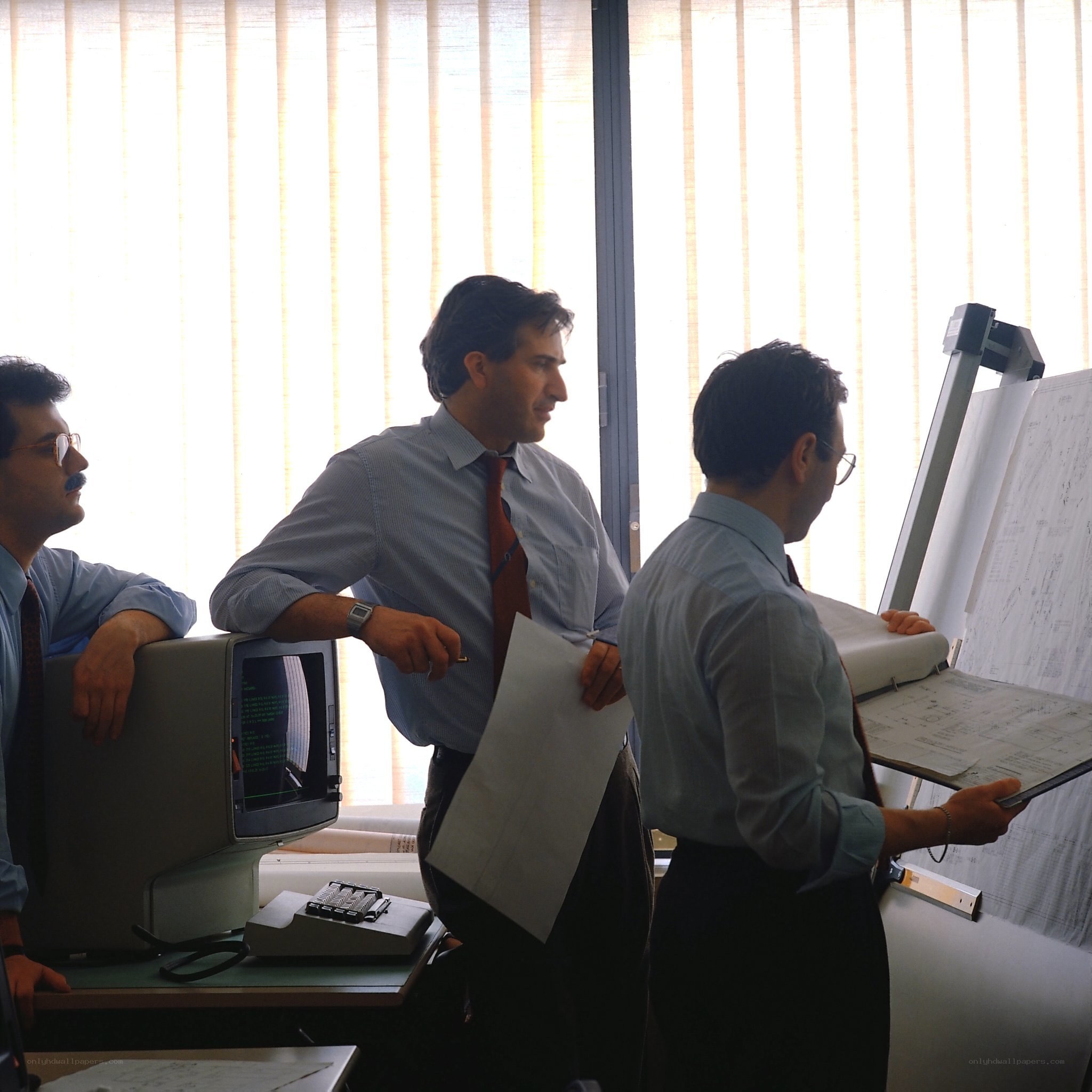 Three men in office discussion
