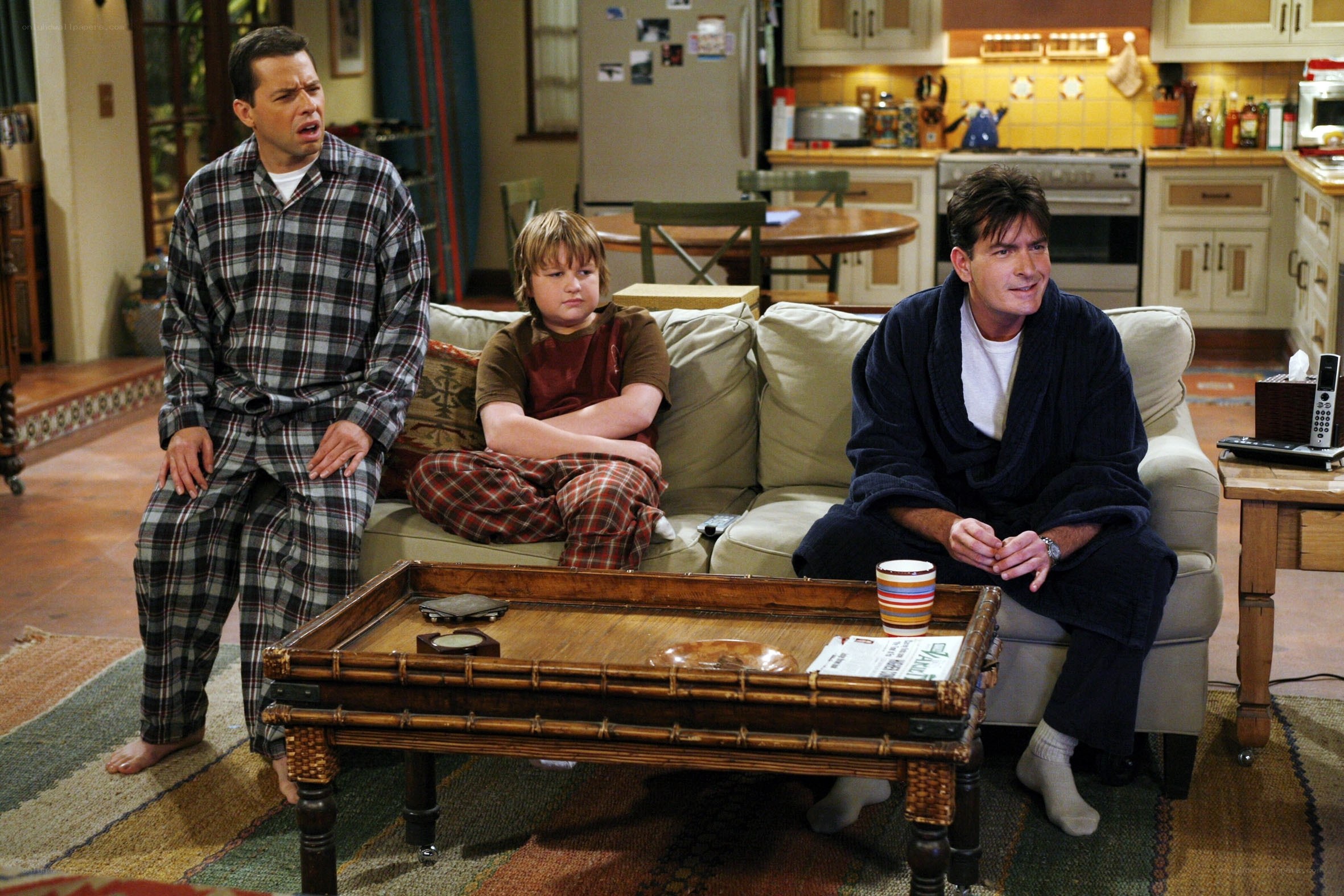 Three men in pajamas on a couch