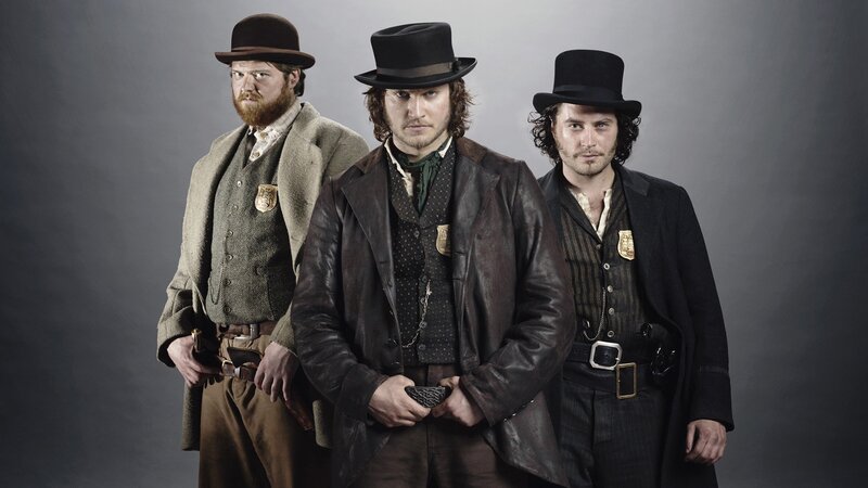 Three men in period law enforcement attire