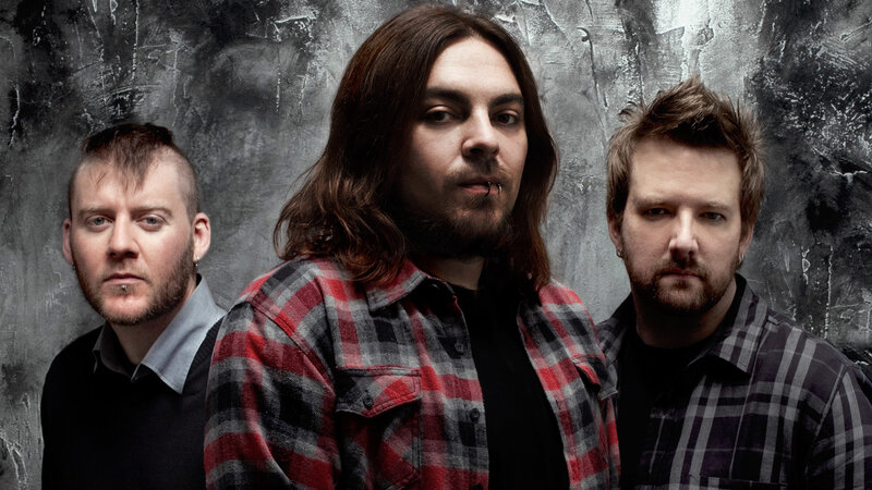 Three Men in Plaid Shirts — Gray, Serious