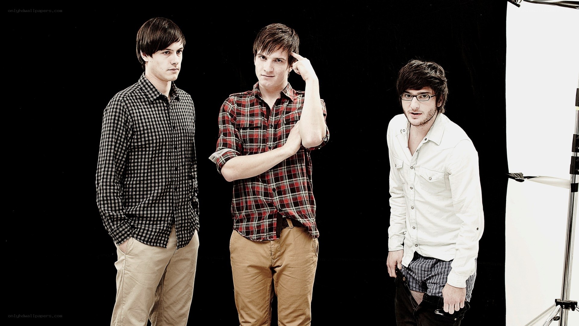 three men in plaid shirts