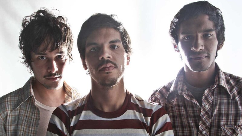 three men in striped and plaid shirts