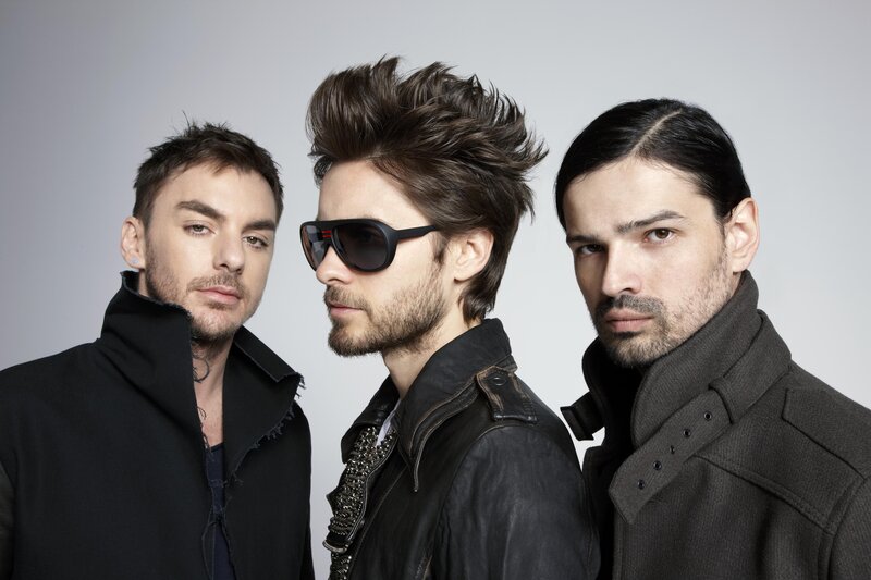 three men in stylish coats