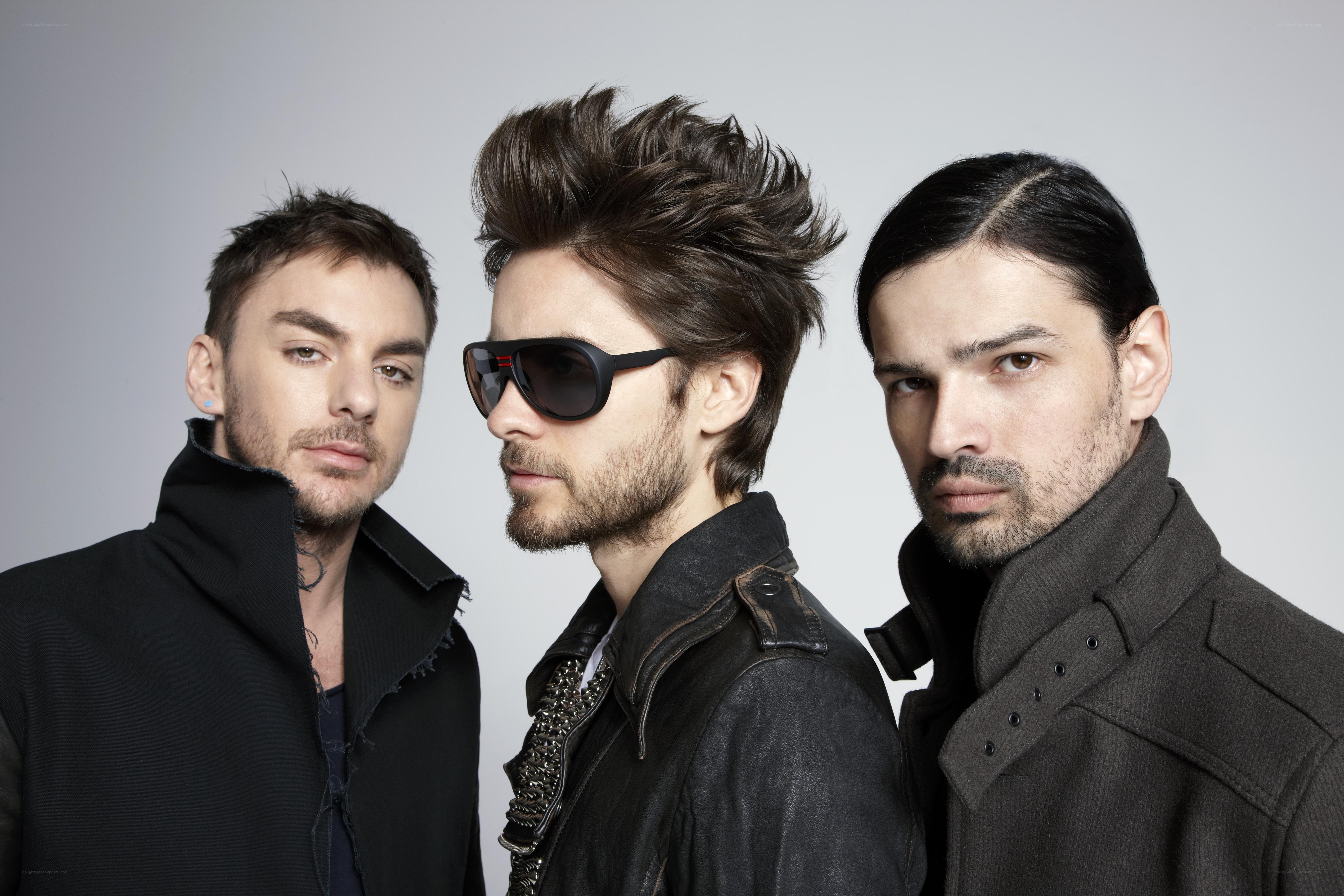 three men in stylish coats