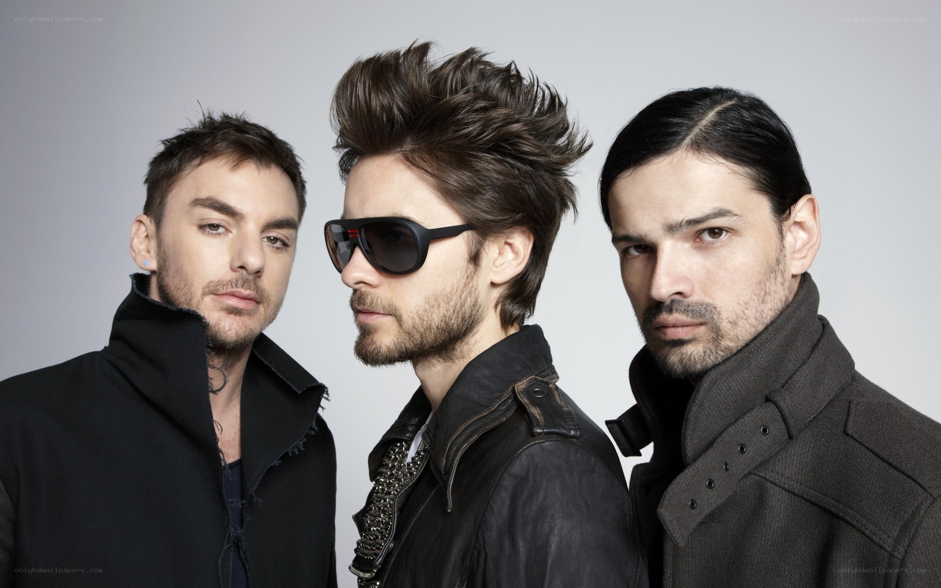 three men in stylish coats