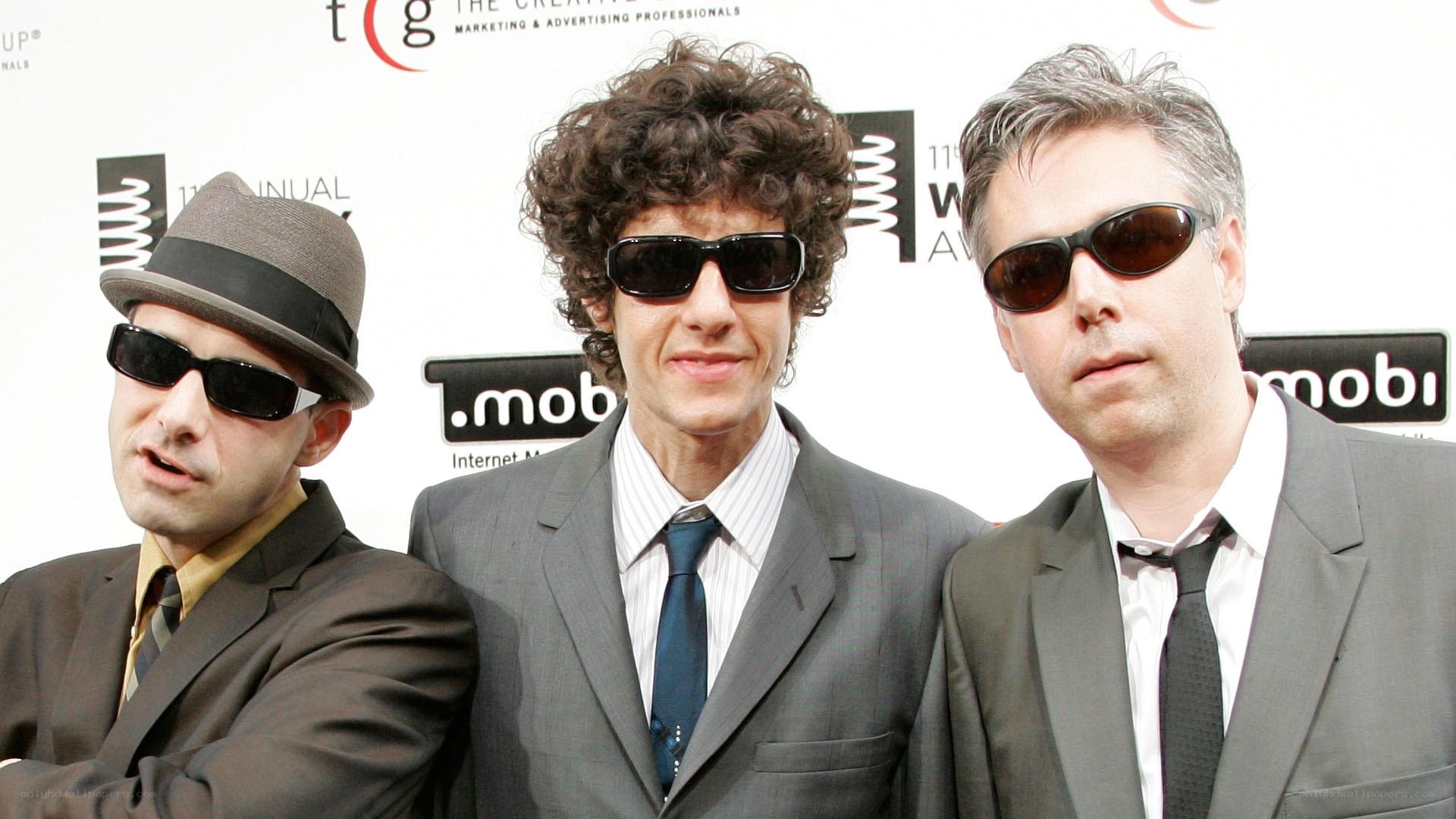 three men in suits and sunglasses