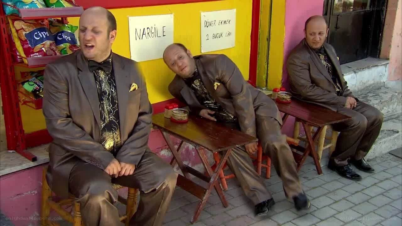 Three men in suits at a snack shop