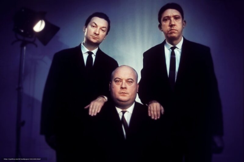 Three men in suits in a studio