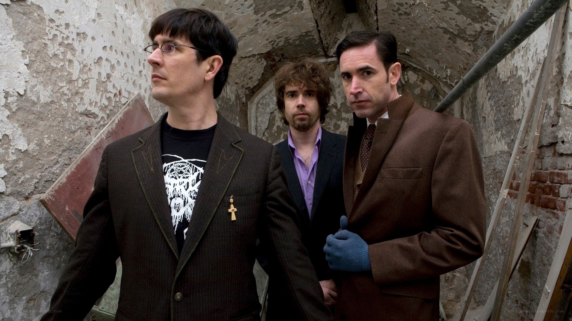 Three men in suits in a tunnel