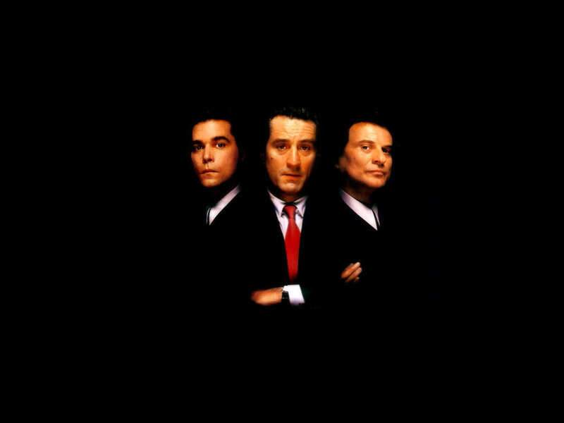 three men in suits on black