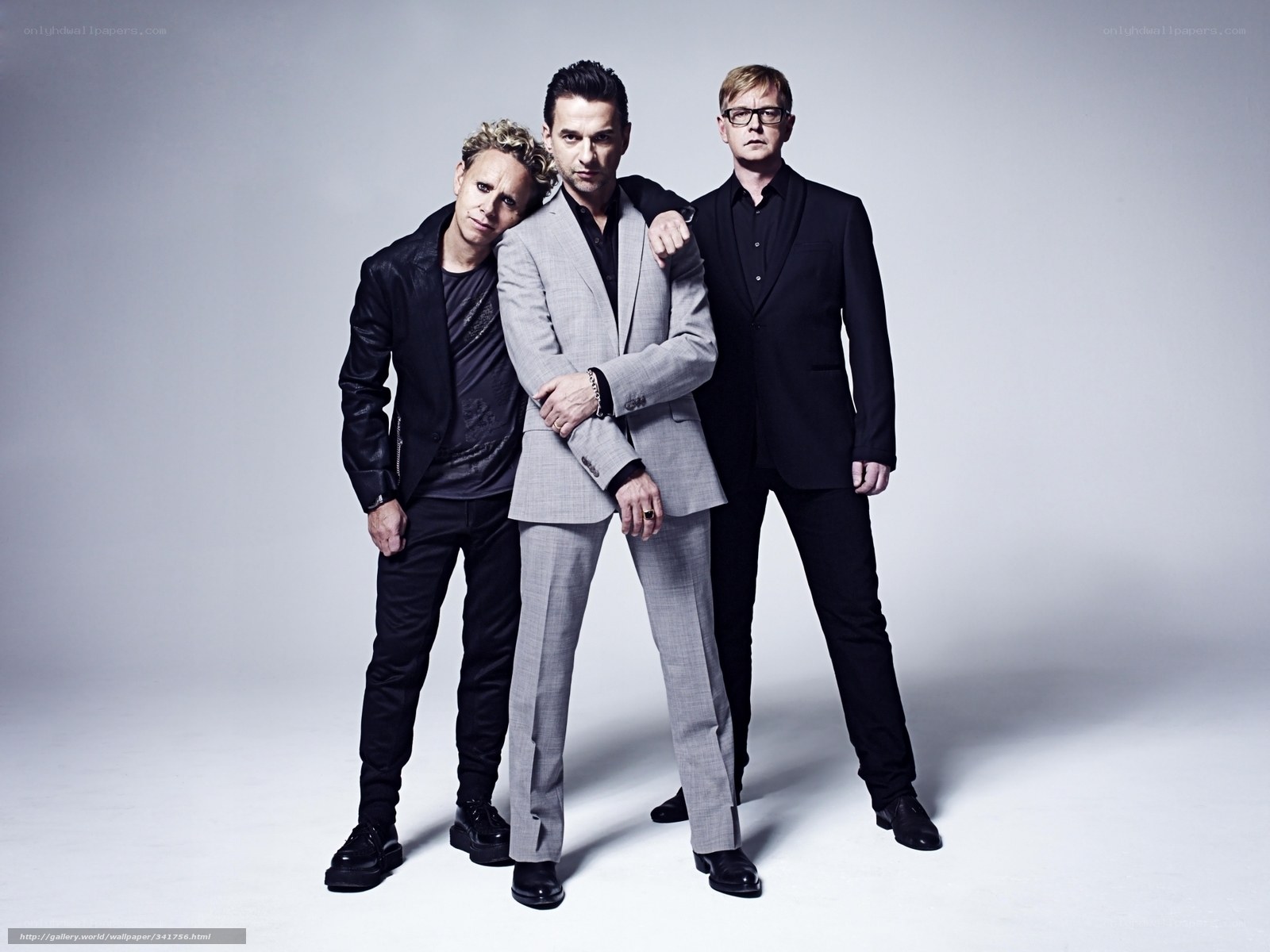 three men in suits posing
