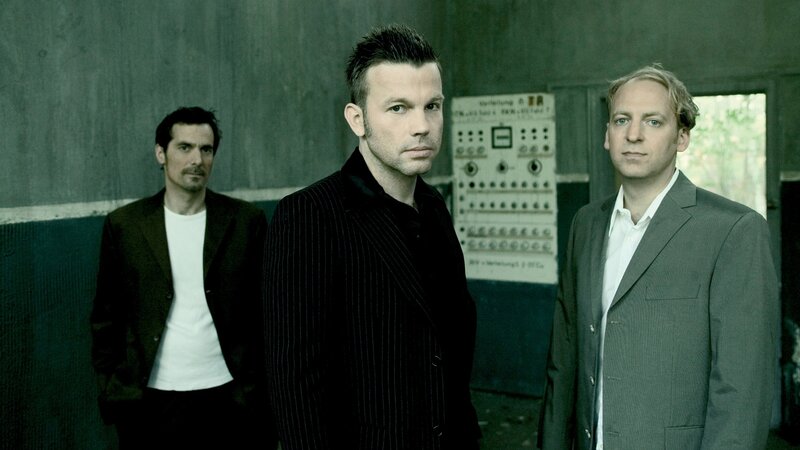 three men in suits standing