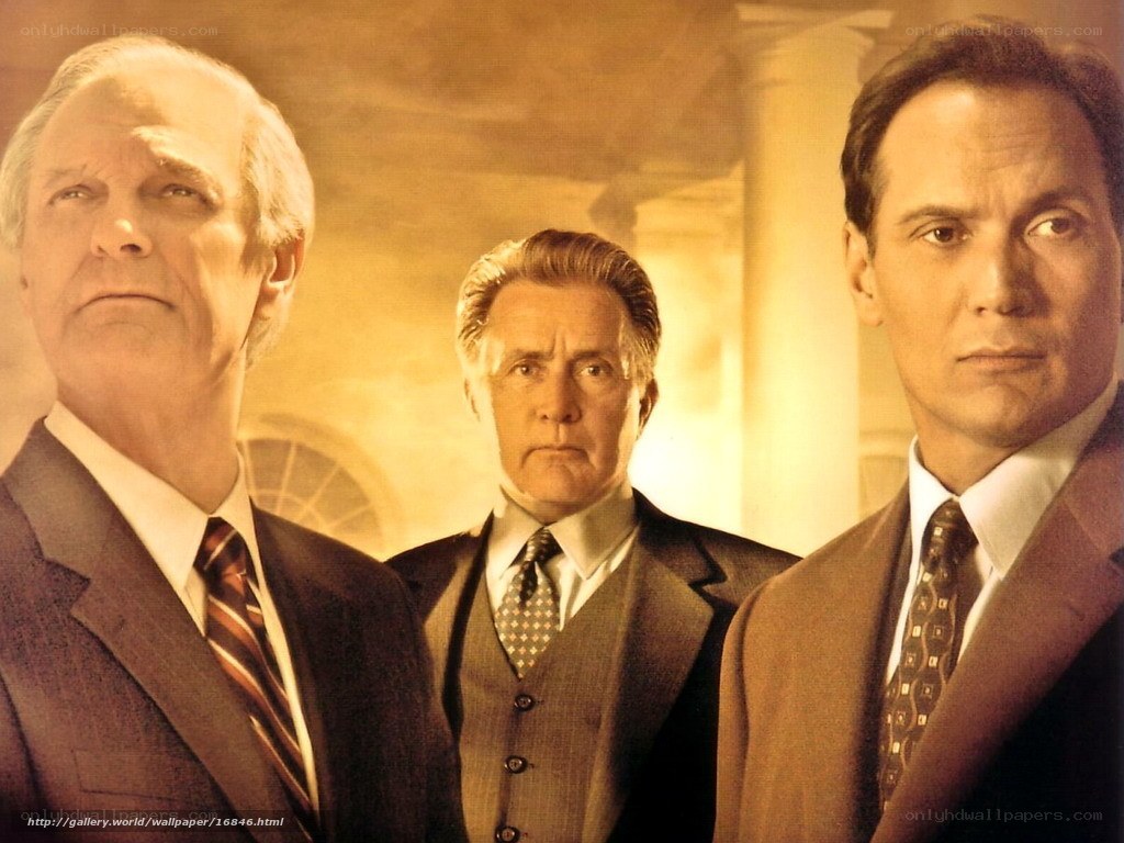 three men in suits standing together