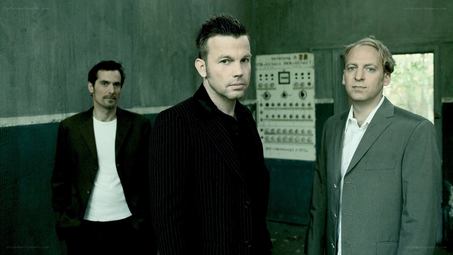 three men in suits standing