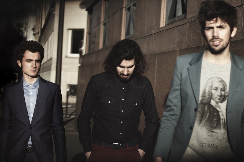 three men in suits walking