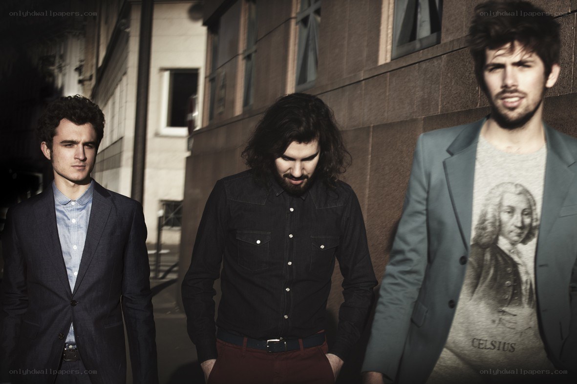 three men in suits walking