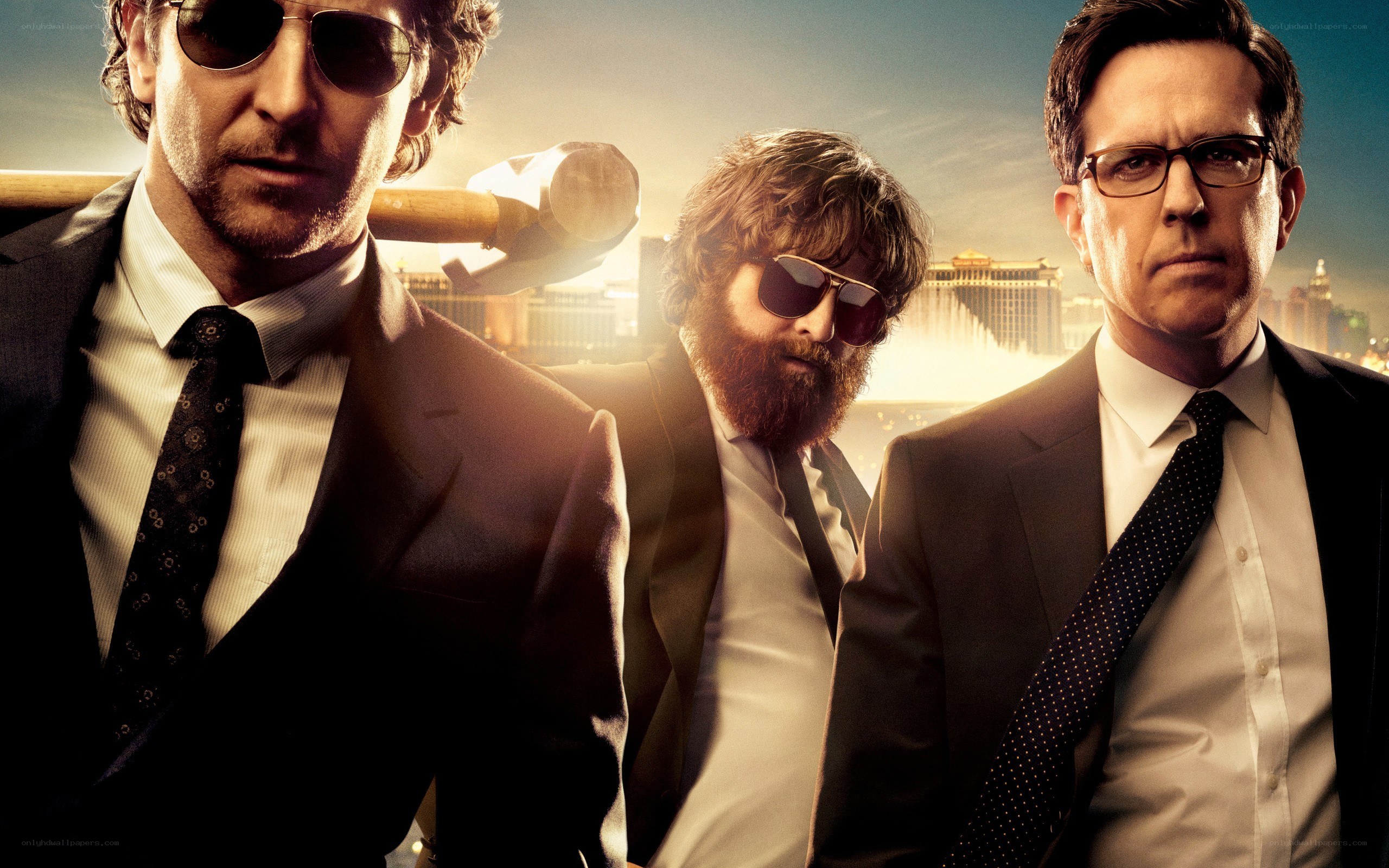Three men in suits with a hammer