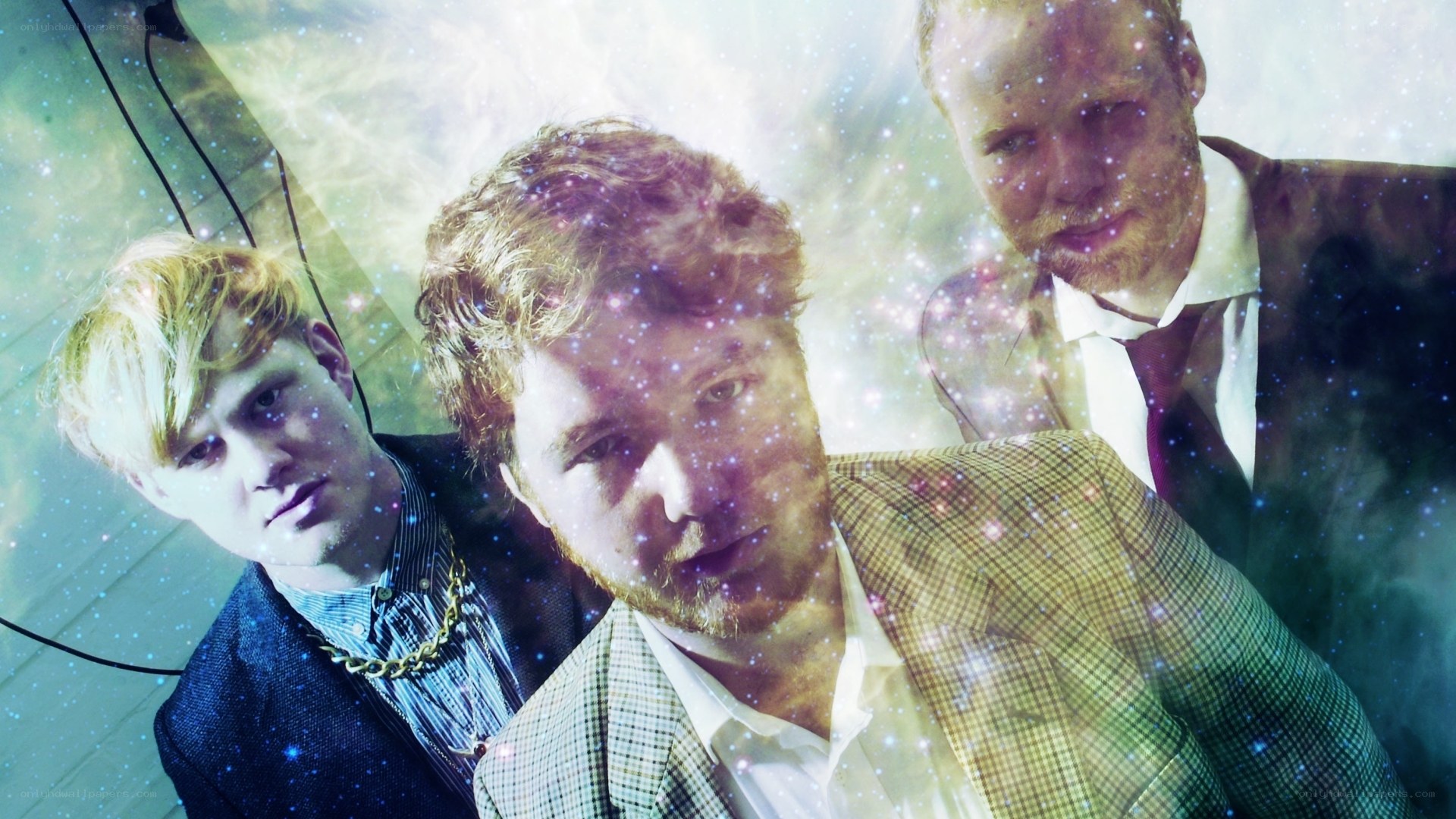 three men in suits with cosmic overlay