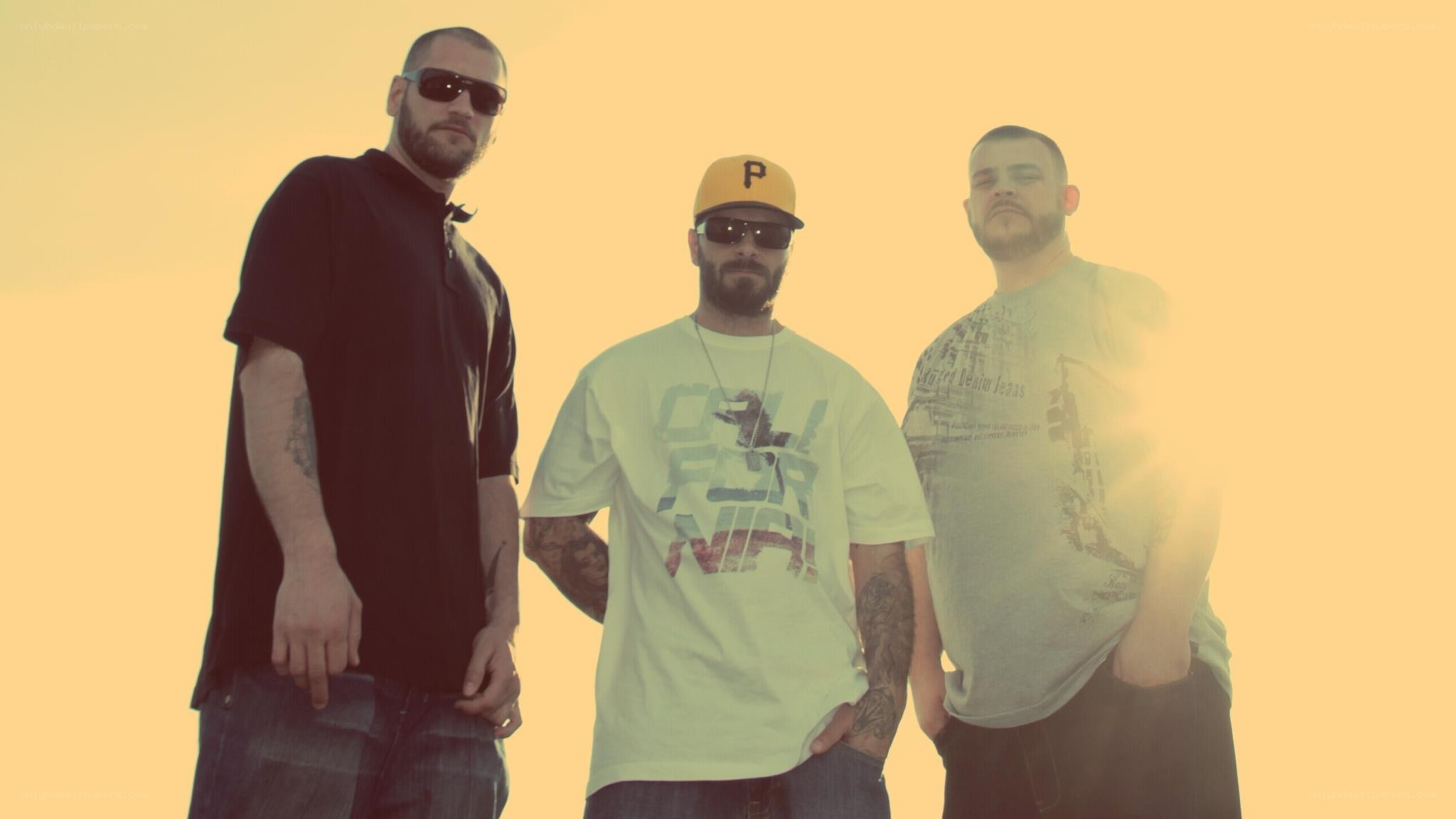 three men in sunglasses and caps