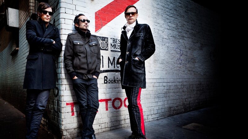 three men in sunglasses and coats