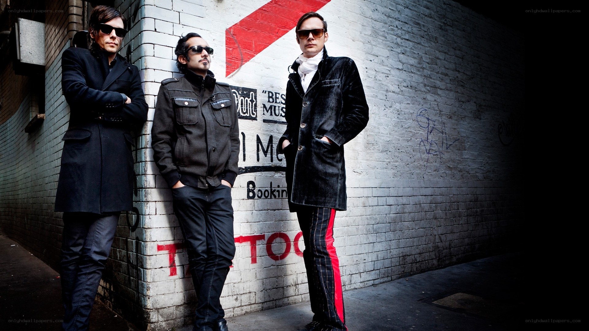 three men in sunglasses and coats