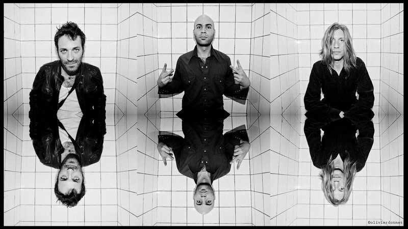 Three men in tiled room