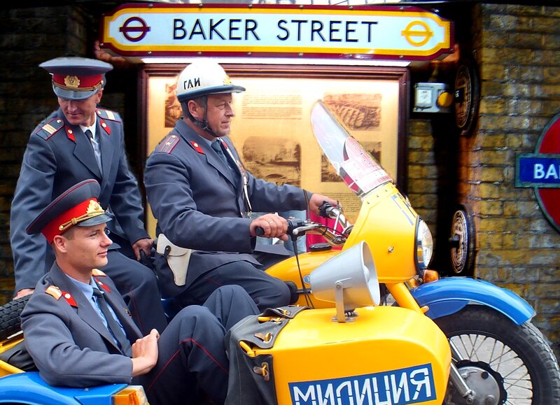 Three Men in Uniform on Motorcycle