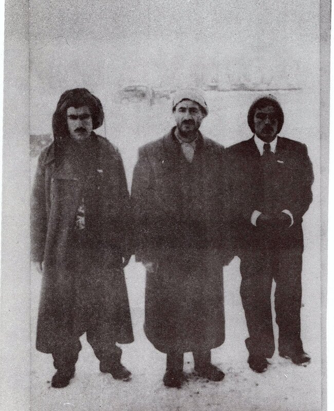 three men in winter coats