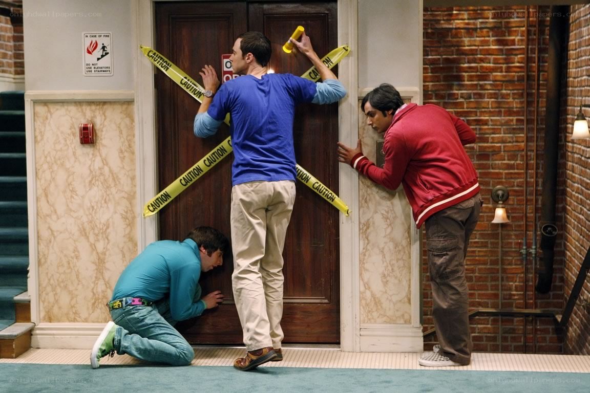 Three men inspecting a door