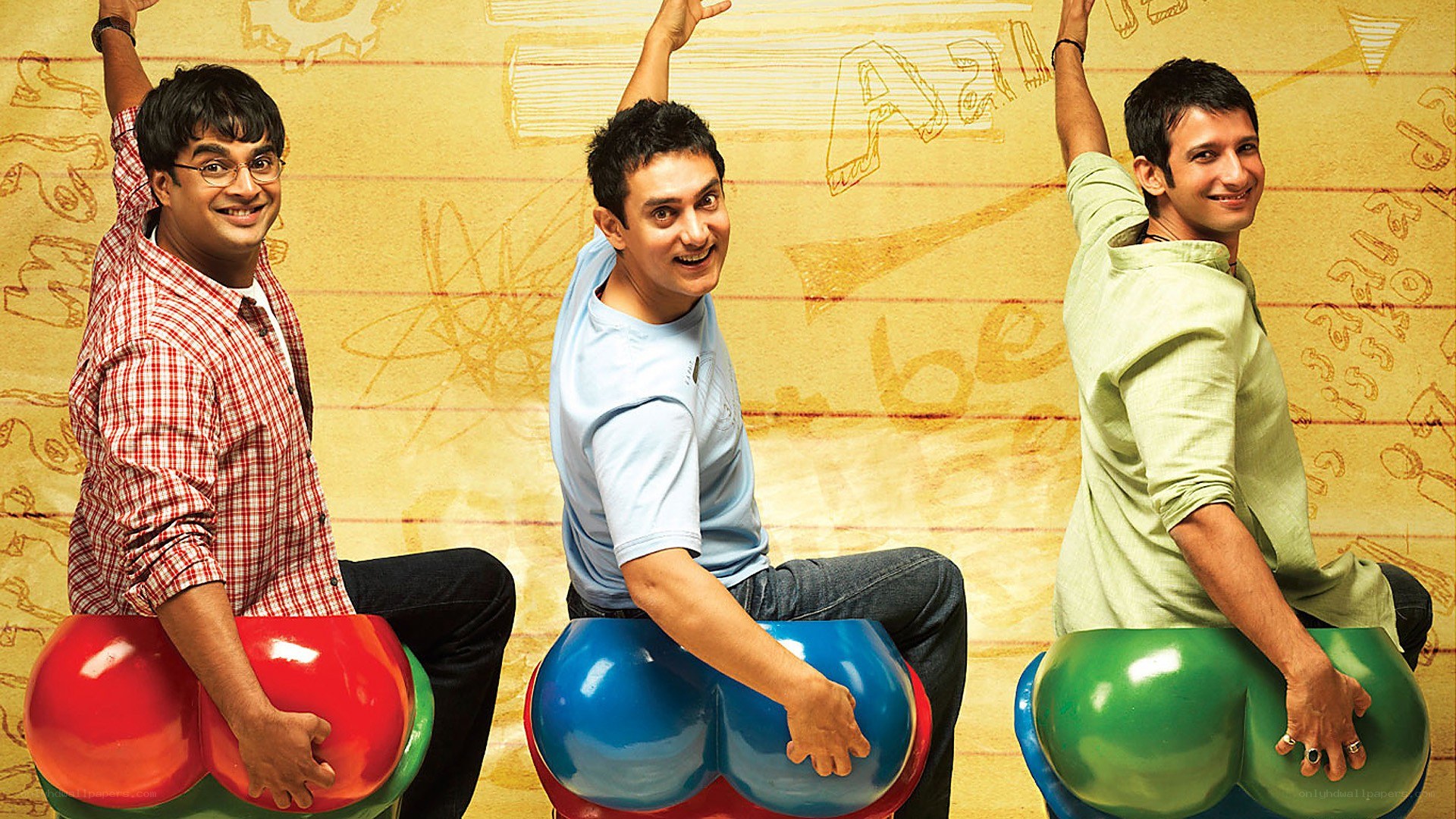 Three men on colorful seats