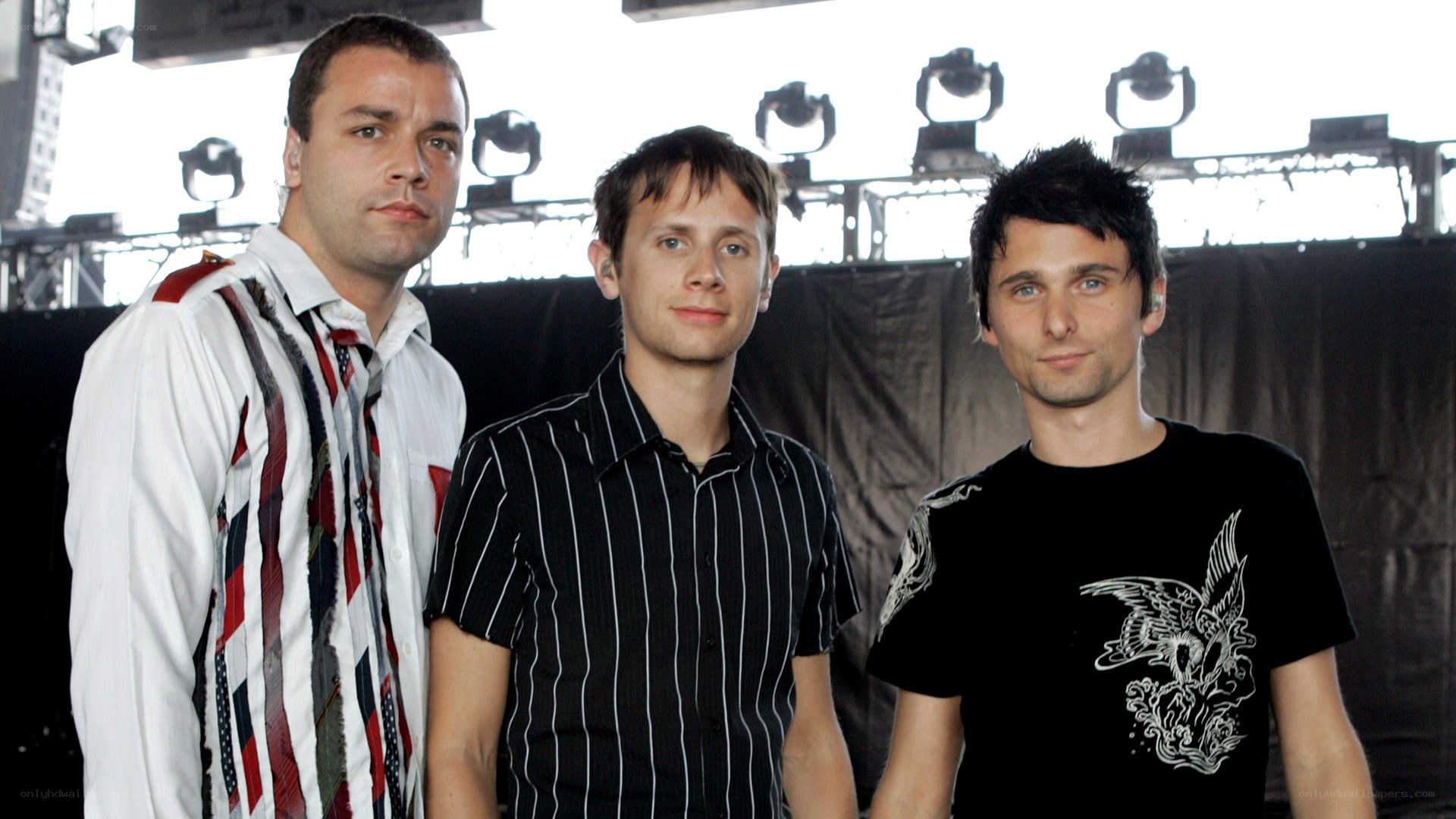 three men on stage