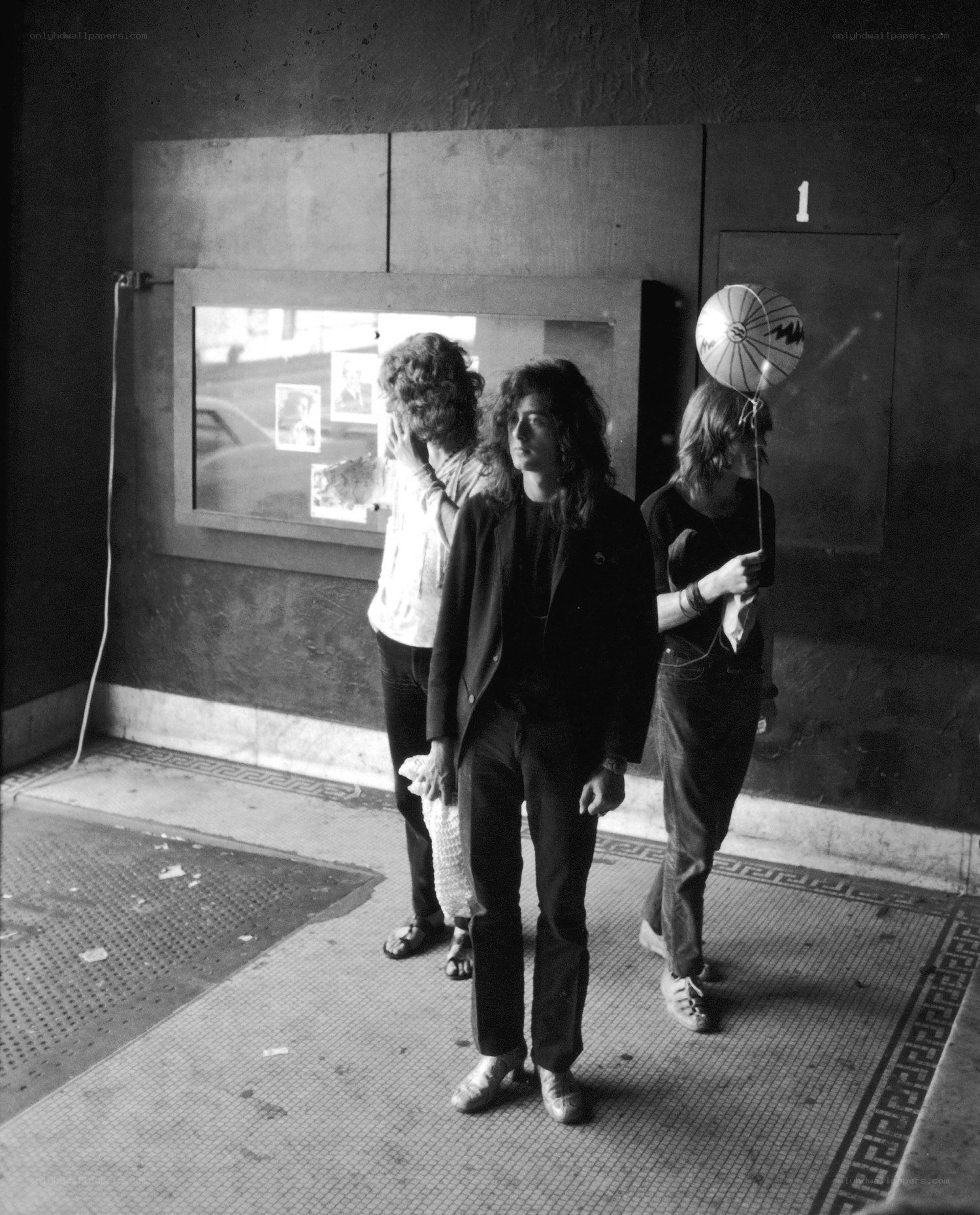 Three men outside a venue