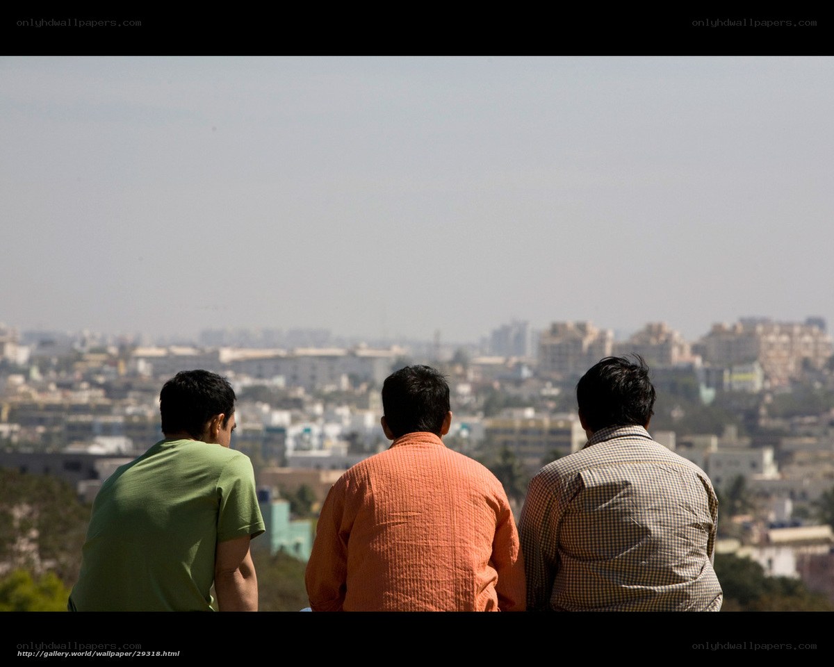 Three men overlooking a city