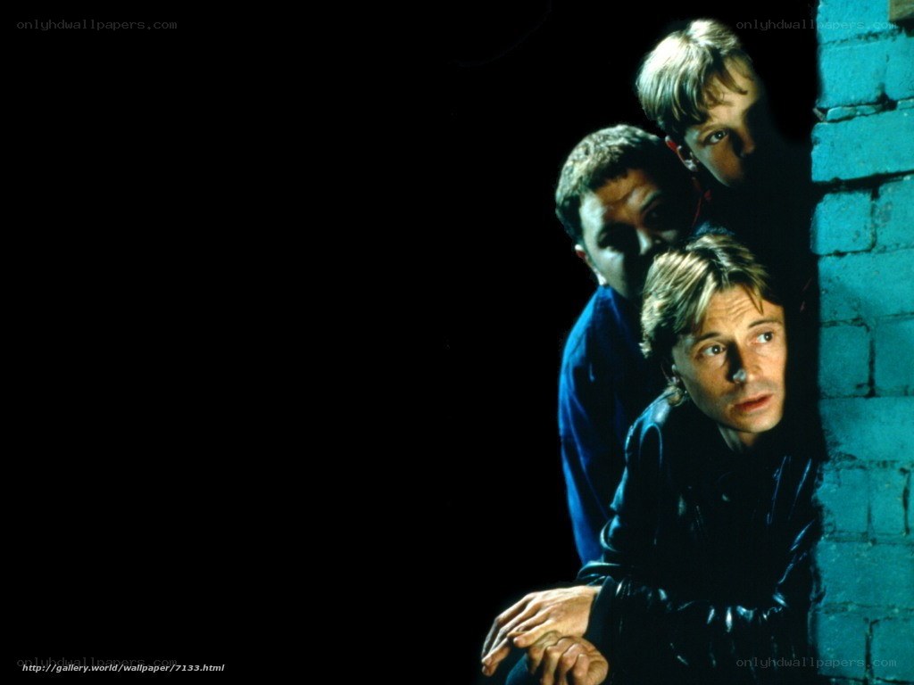 three men peeking from corner