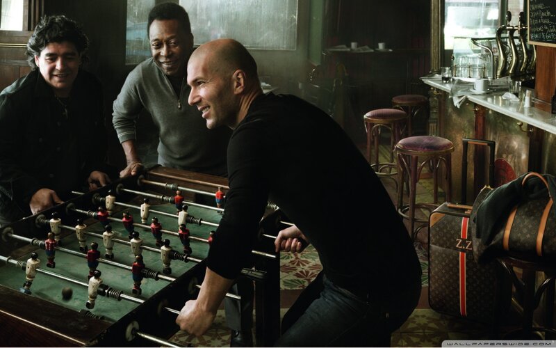 Three Men Playing Foosball