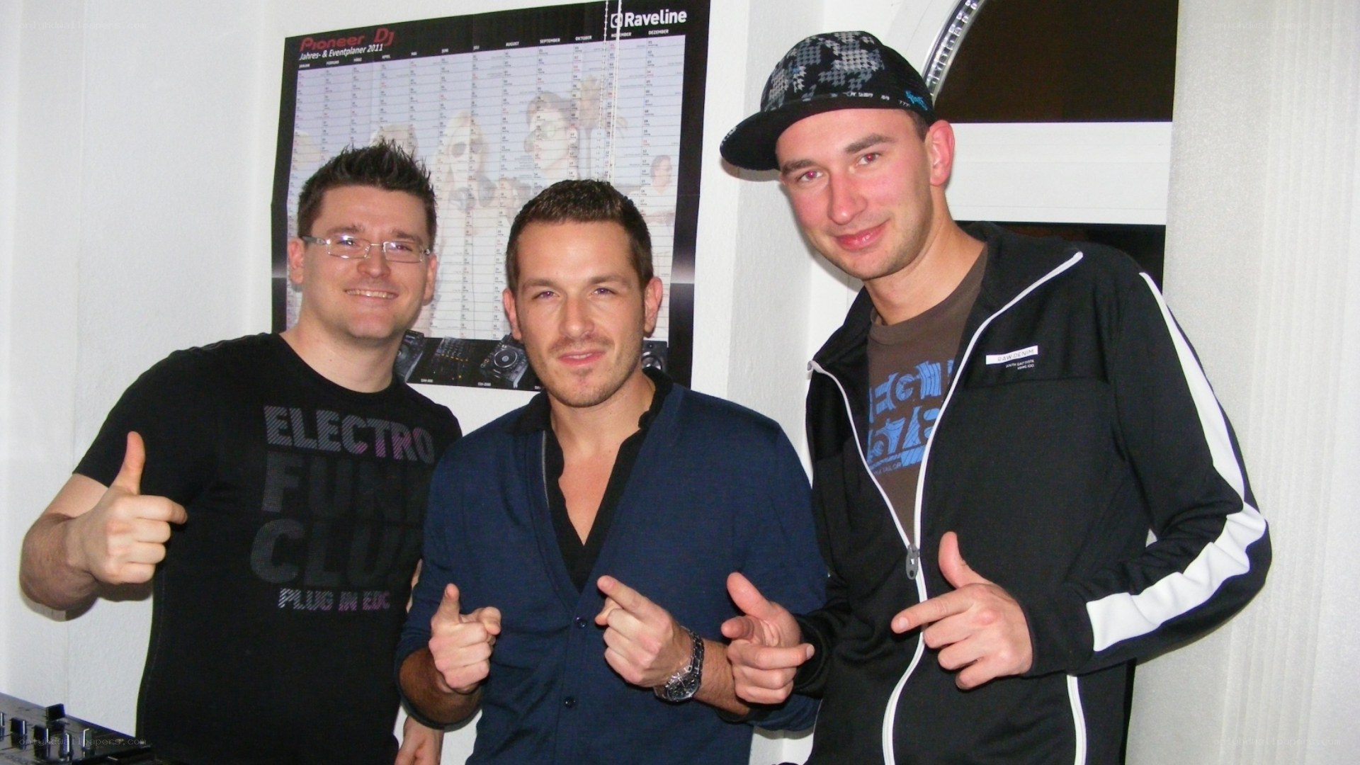 Three men posing at a DJ event