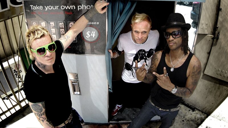 three men posing by photo booth