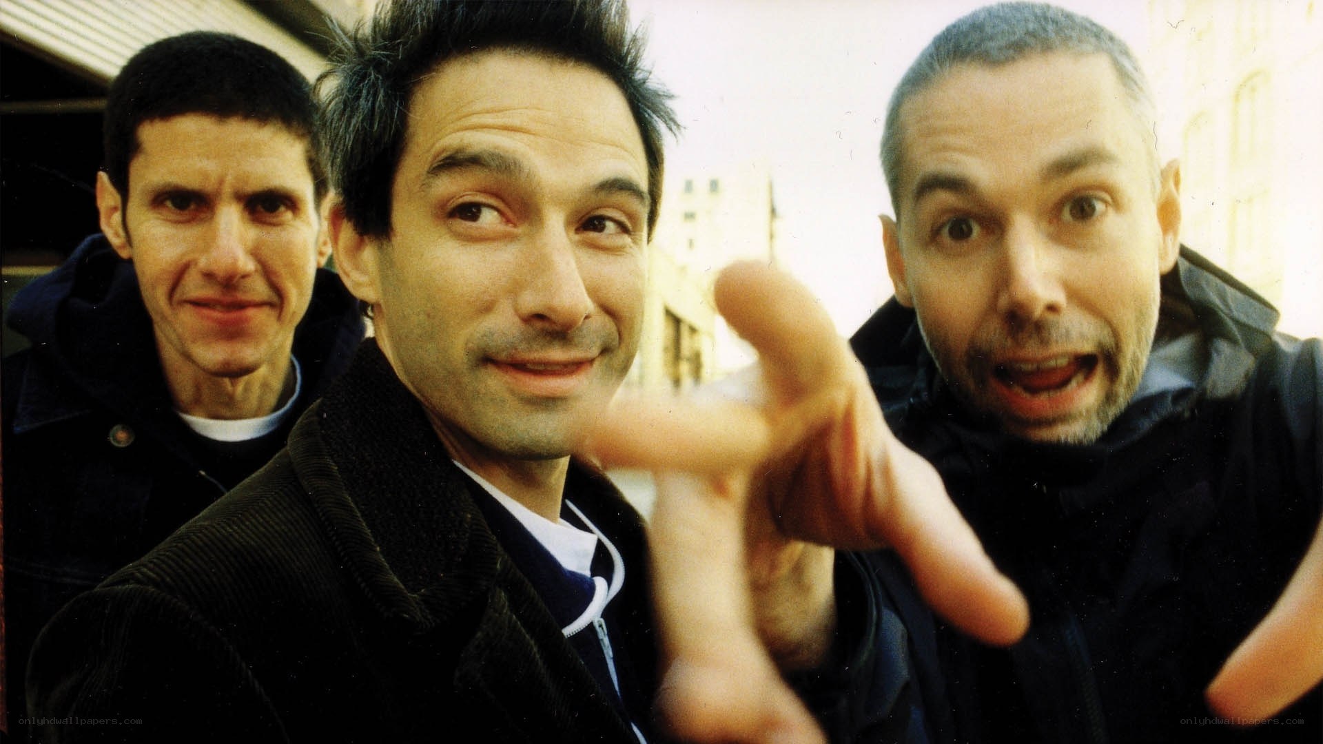 three men posing for camera