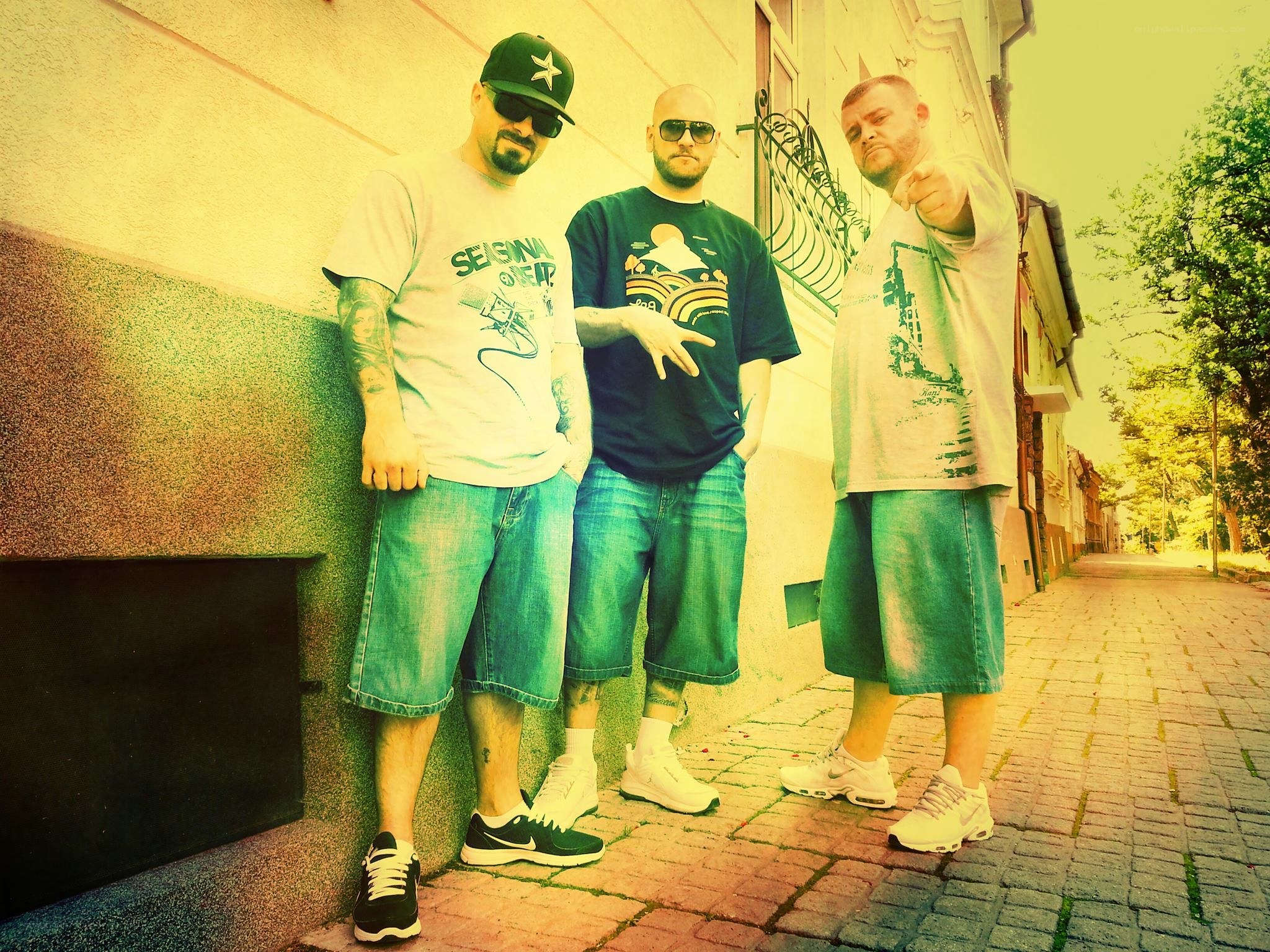 three men posing on a street