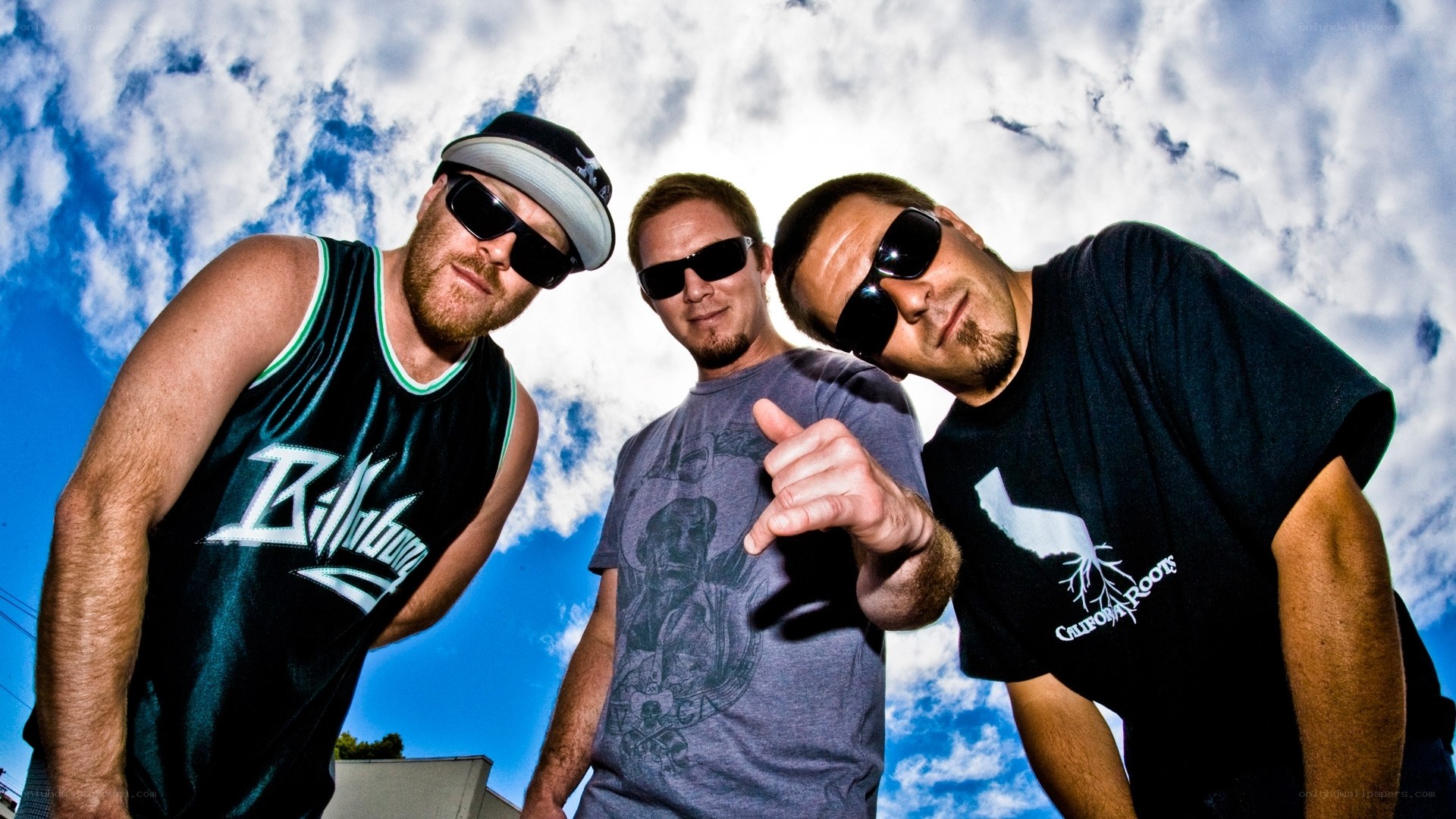 three men posing outdoors