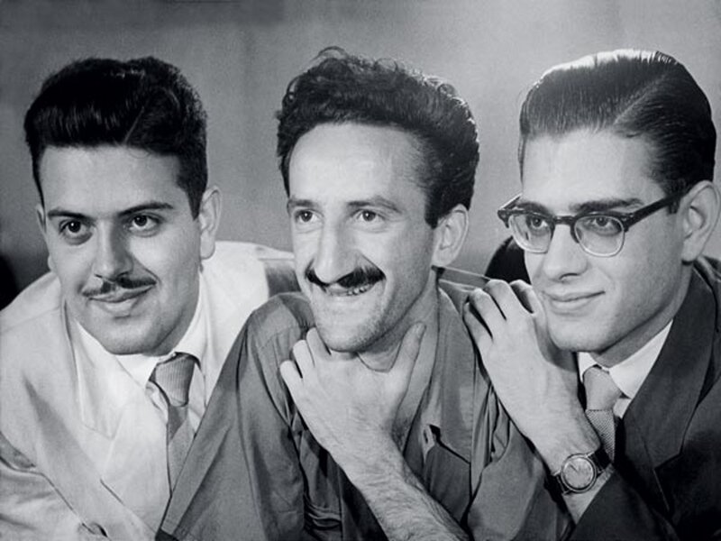 Three Men Posing Together — Black, Neutral, Photograph, Suits