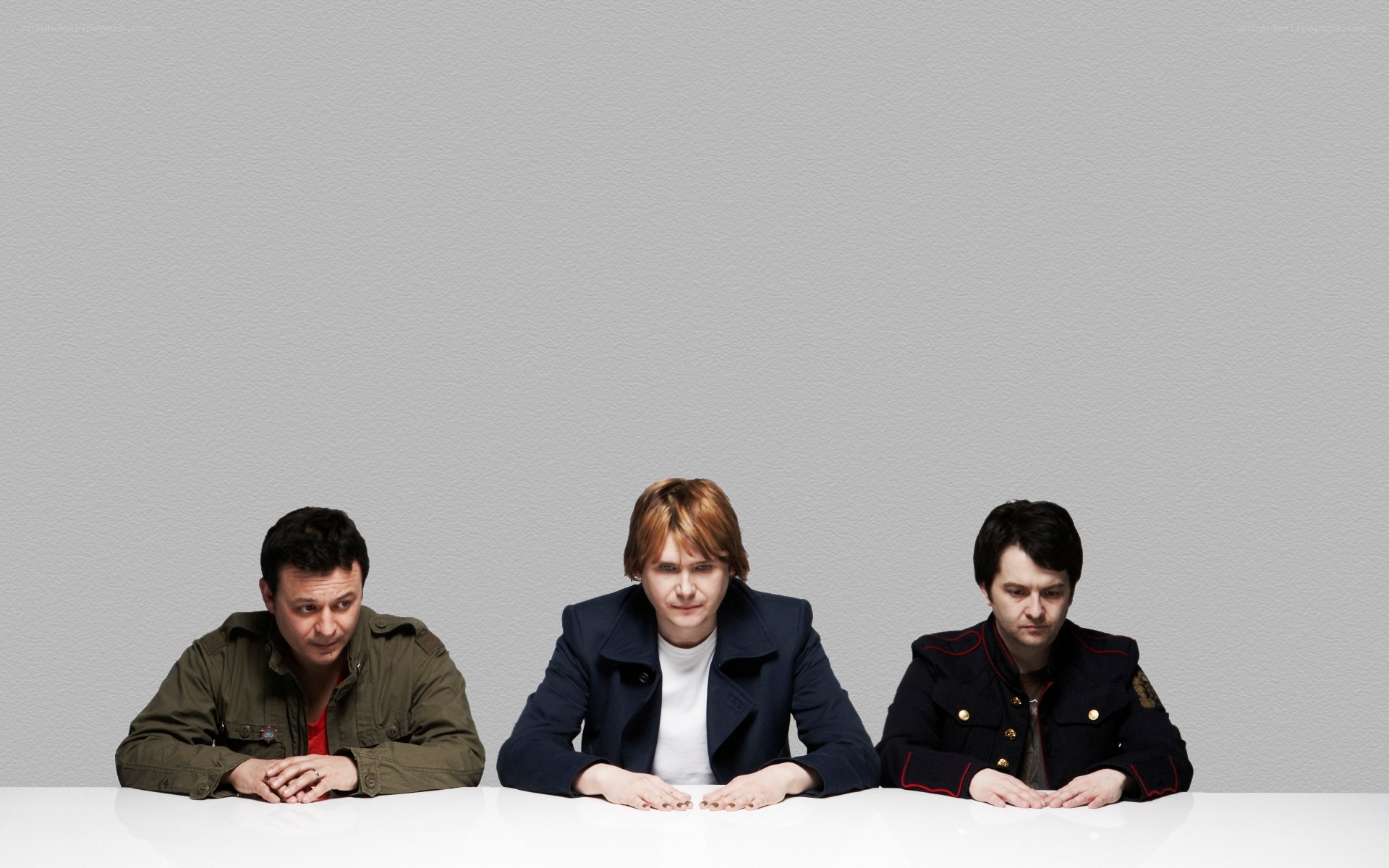three men sitting at a table