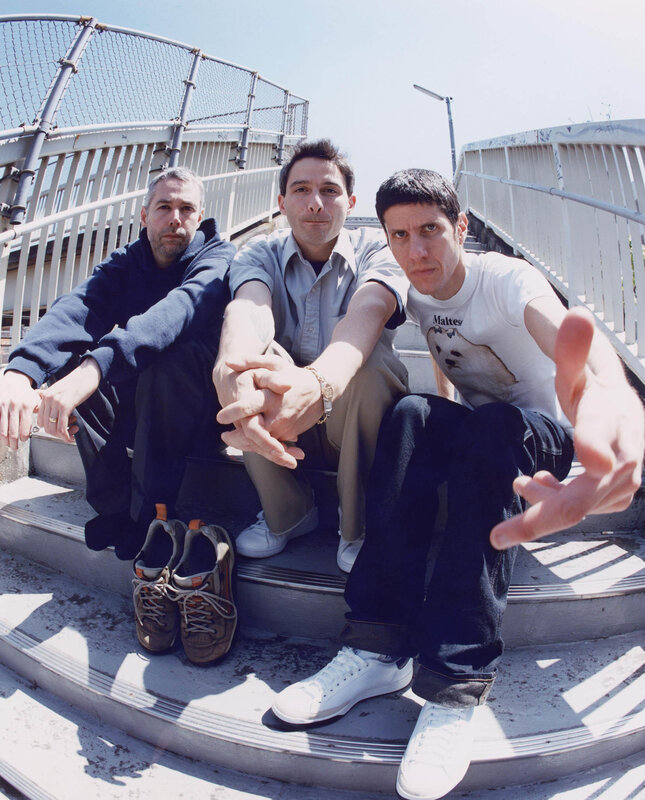 three men sitting on stairs
