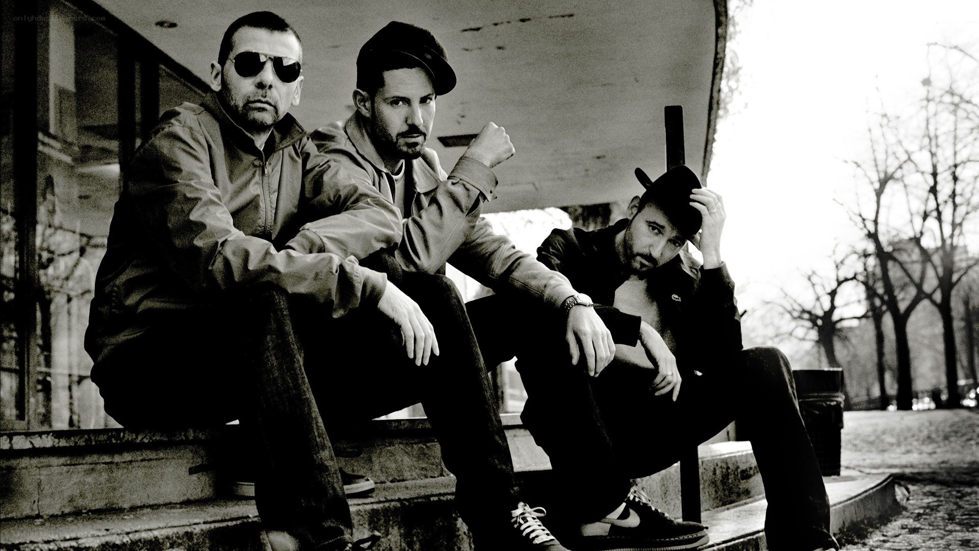 three men sitting on steps